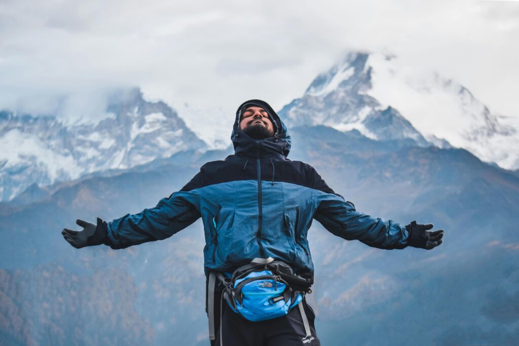 A man embraces the freedom of the mountains in Ghode Pani, Nepal.