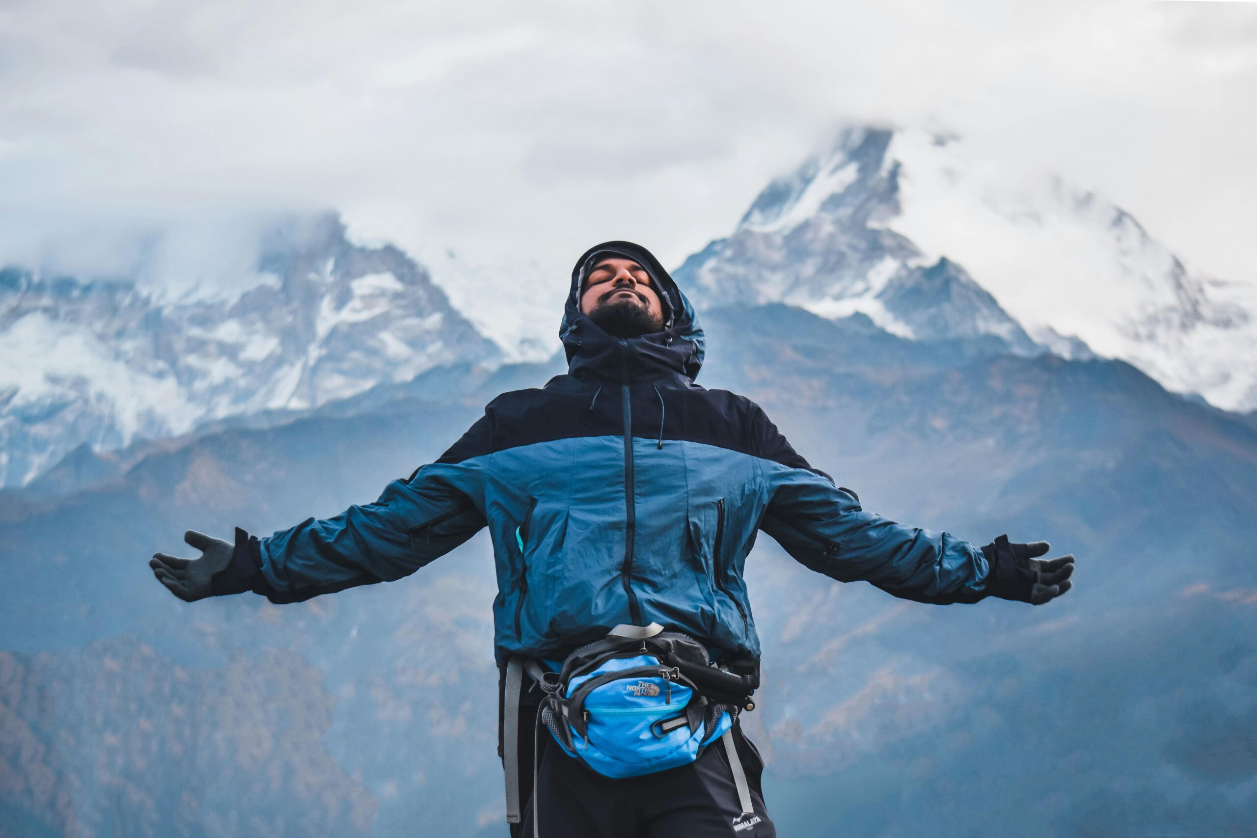 A man embraces the freedom of the mountains in Ghode Pani, Nepal.