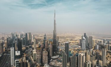 A breathtaking aerial view of Dubai's skyline featuring Burj Khalifa amidst modern skyscrapers under a clear sky.