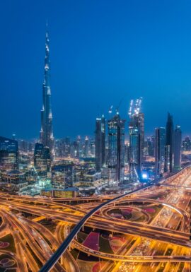 A breathtaking aerial view of Dubai's skyline with Burj Khalifa lit at night.