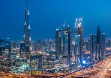 A breathtaking aerial view of Dubai's skyline with Burj Khalifa lit at night.
