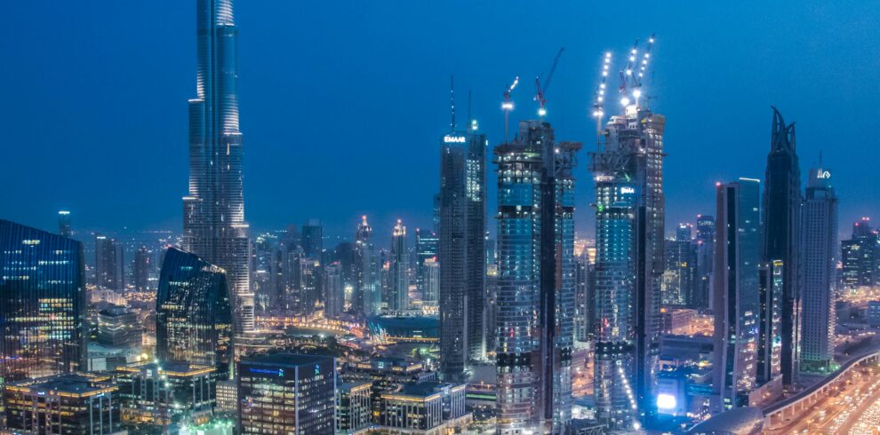 A breathtaking aerial view of Dubai's skyline with Burj Khalifa lit at night.